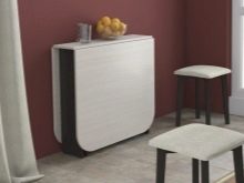 Розкладний обідній стіл-книжка для вітальні: як вибрати вузький стіл-трансформер для залу круглої і квадратної форми?